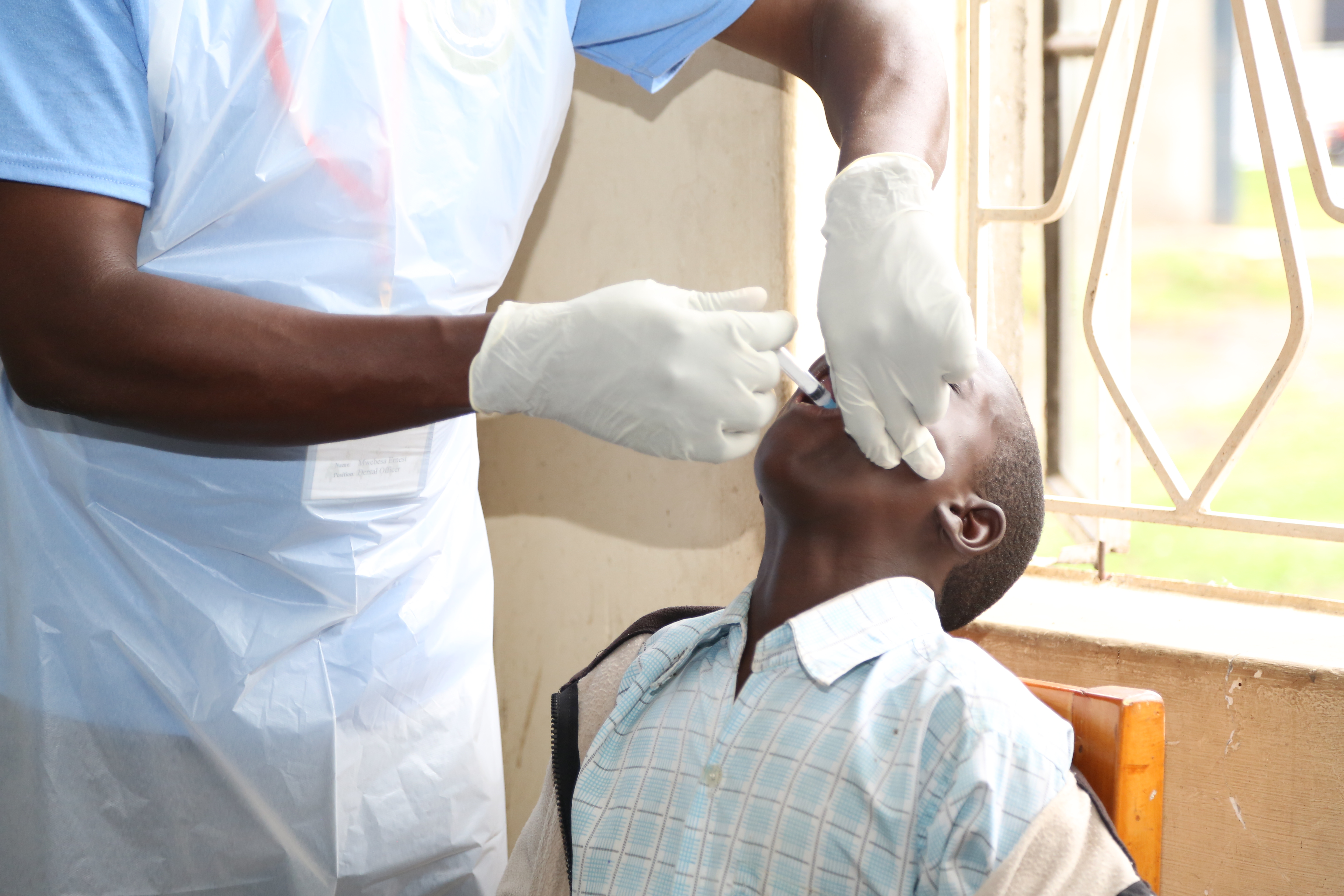A DENTIST TREATING A PATIENT AT THE MEDICAL CAMP
