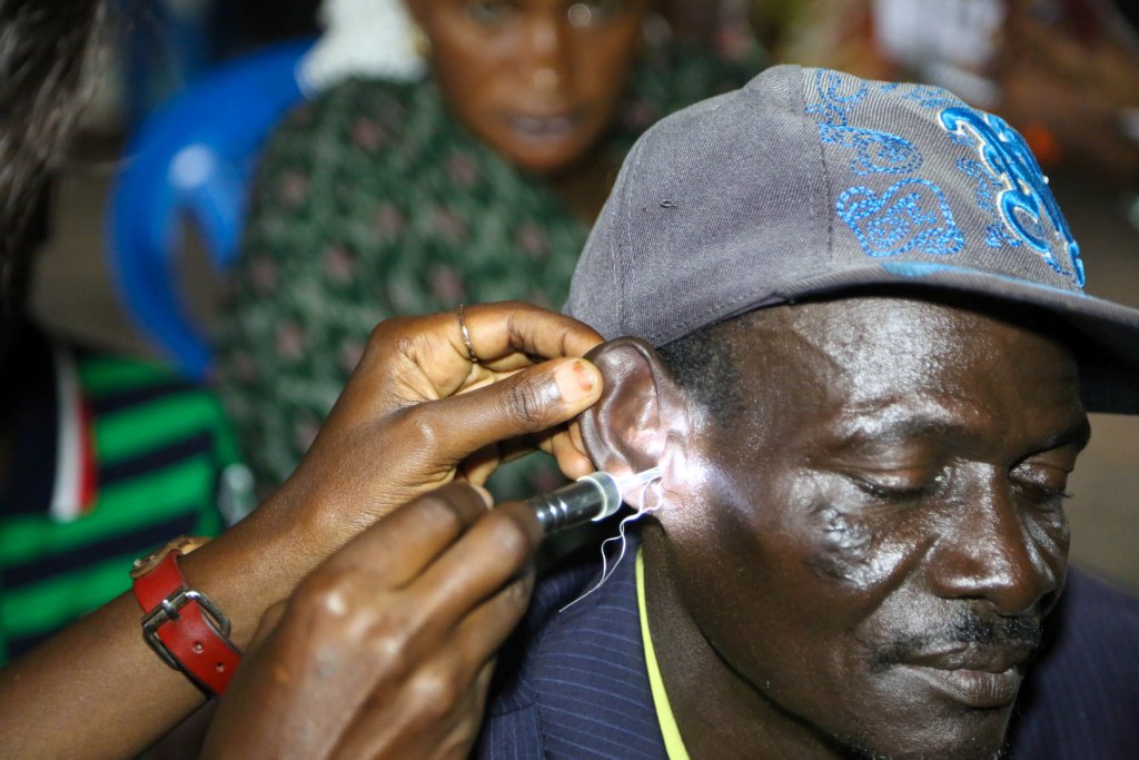 AN ENT MEDIC TREATING A PATIENT'S EAR
