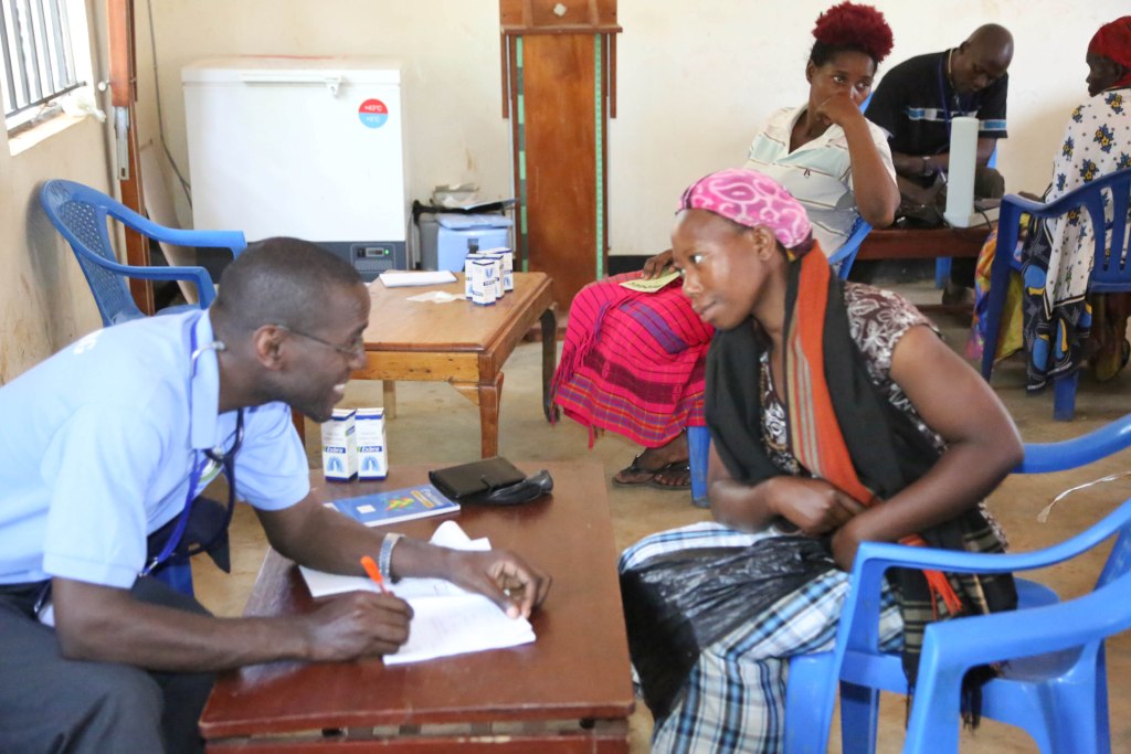 DR. ROBERT ATTENDING TO A PATIENT DURING 2017 MEDICAL CAMP